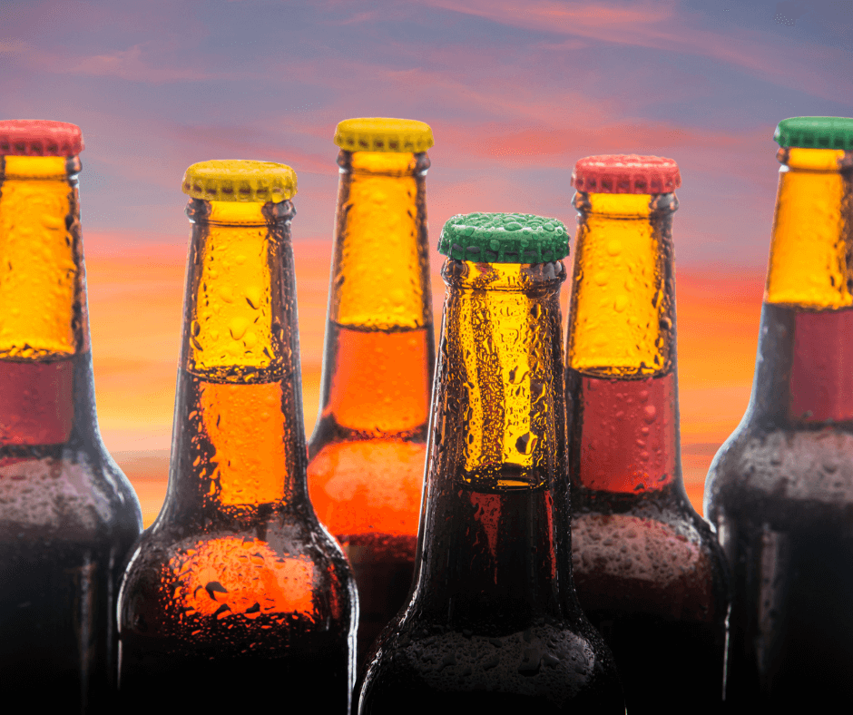 straight on view of beer bottle necks against sunset